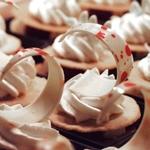 Dessert displays featuring hand held tarts with custom curled while chocolate topping